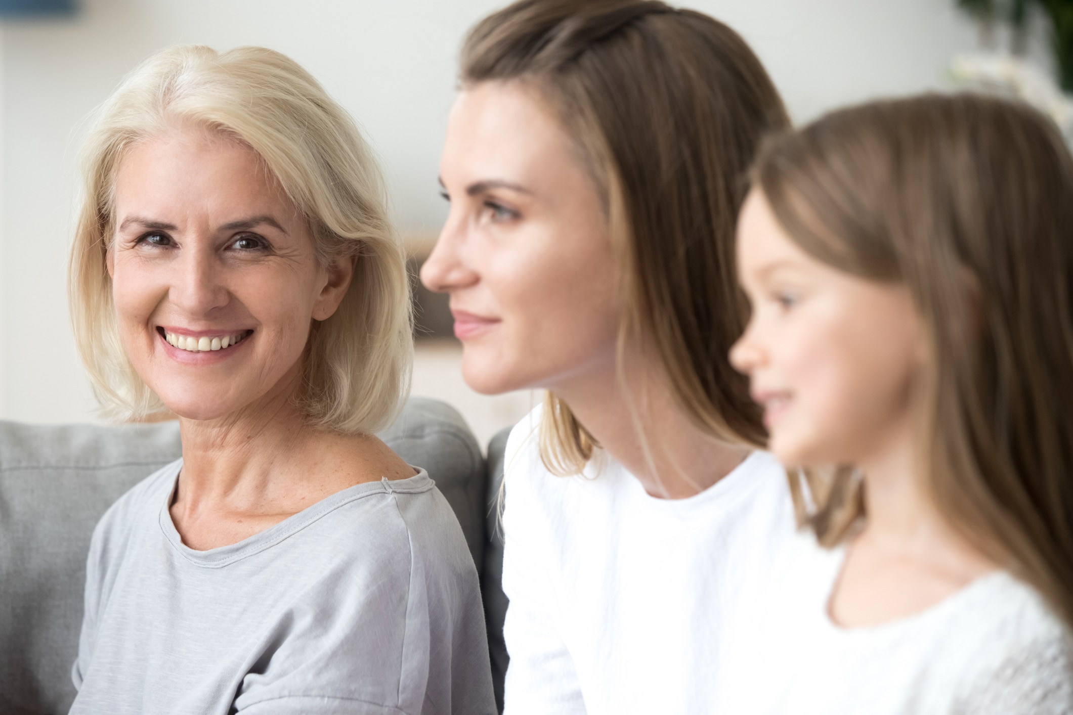 Grandmother, mother, and child together at home